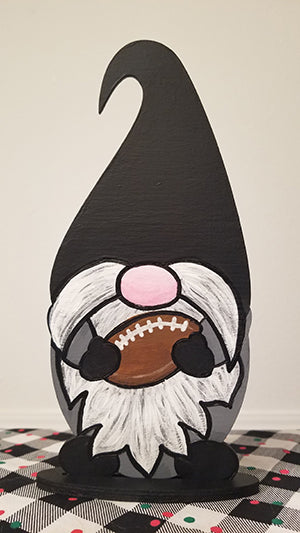 Wooden football gnome, freestanding painted in black grey and white colors as he holds his football 4x7x1.5 inches big, 3 mil plywood 