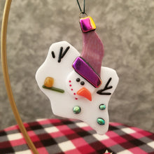 Load image into Gallery viewer, Adorable melted snowman fused glass ornament with purple hat with dichroic gold purple trim and green dichroic buttons #ornament