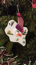 Load and play video in Gallery viewer, Adorable melted snowman fused glass ornament with purple hat with dichroic gold purple trim and green dichroic buttons #ornament
